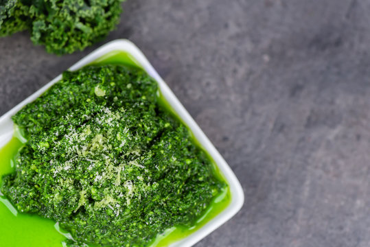 Pesto made from kale, cheese, lemon, pine nuts and garlic - close up - top view - copy space