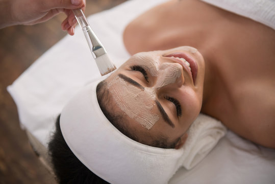 Pleasant feeling. Cheerful happy woman smiling and while enjoying the beauty procedure