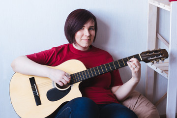 beautiful young woman playing guitar