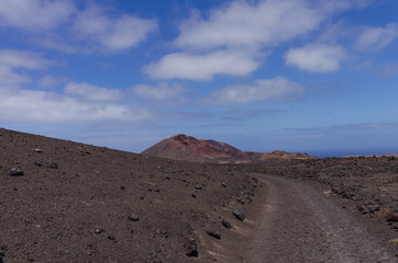 Volcanoes near the hiking trail in Timanfaya National Park on Lanzarote, the Canary Islands