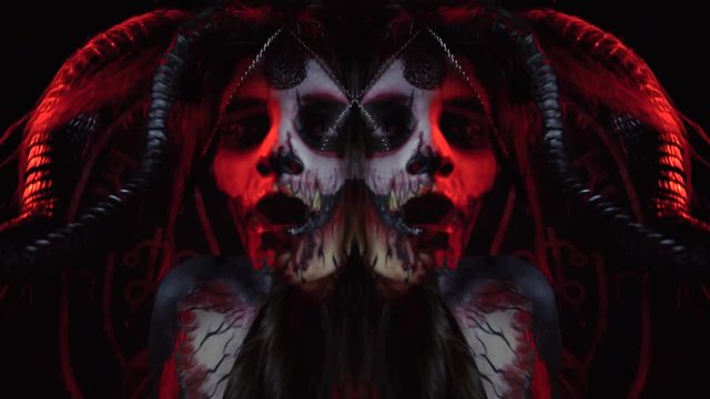 The demoness dances a ritual dance in the darkness