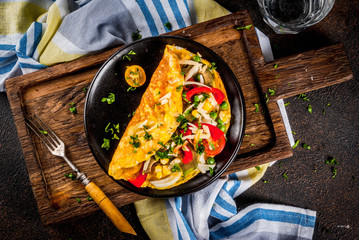 Healthy breakfast food, Stuffed egg omelette with vegetable, dark concrete background copy space top view