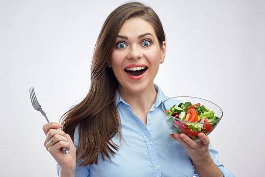 Surprising woman holding salad bowl with fork.