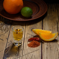 Mezcal shot with orange slices and worm salt. Mexican drink.