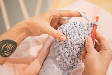 Handmade process. woman hands knitting crochet. hobby crafts things. Horizontal composition. Warm toned hipster photo