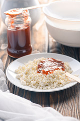 tasty healthy cottage cheese with jam on wooden table
