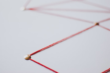 Linking entities. Network, networking, social media, connectivity, internet communication abstract. Web of red thread on white background.