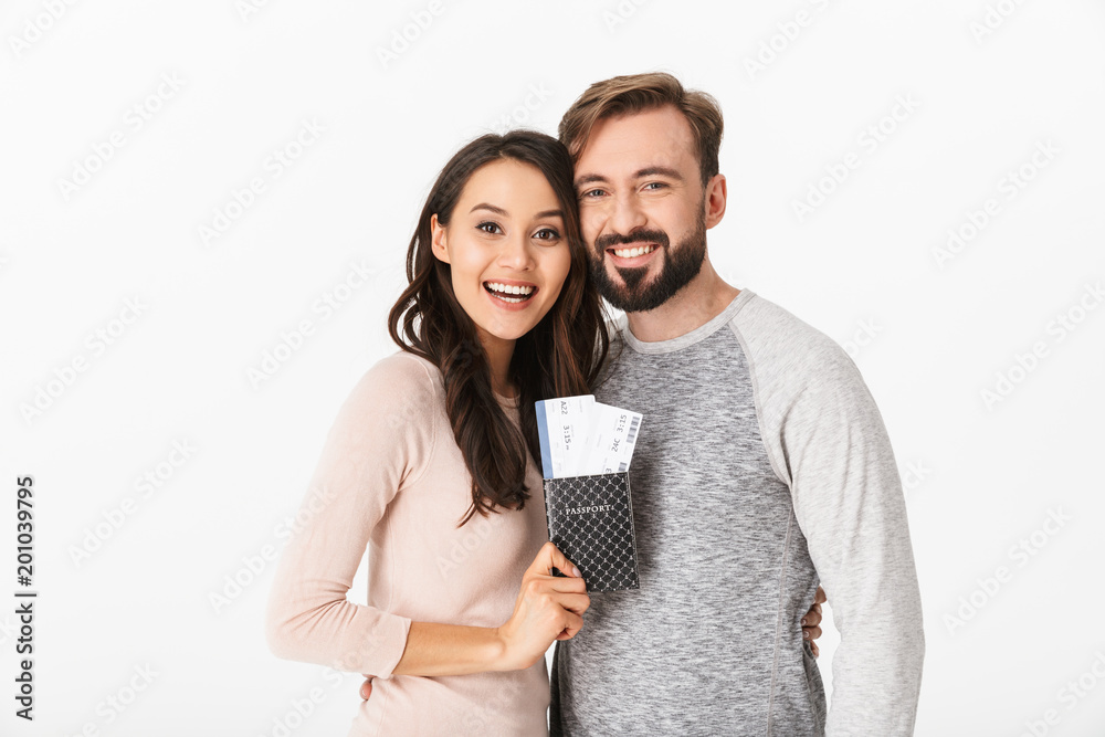 Canvas Prints Cheerful young loving couple holding passport and tickets.