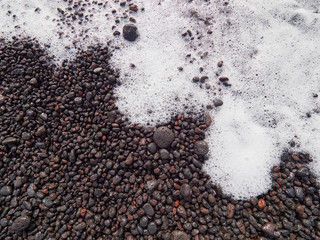 Weathered, rounded lava pebbles on the beach of Stromboli island, Sicily, Italy
