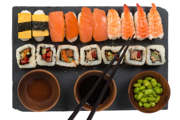 Variety sushi on stone plate on white isolated background.