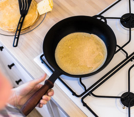 Baking pancakes on a cast-iron frying pan