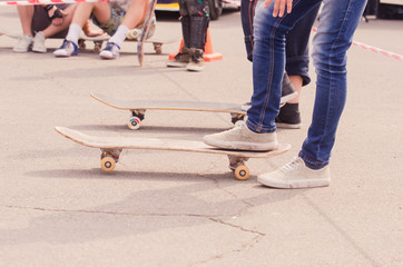 Fototapeta premium young skateboarder legs riding skateboard at city skatepark