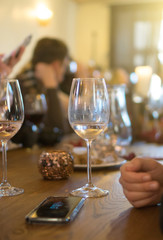 Glass of white wine on the table. Party in the bar.