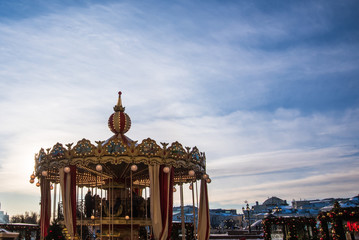 Fototapeta premium Vintage carousel ride spins in the air at sunset