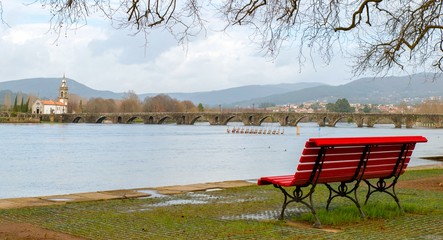 Park bench near full river