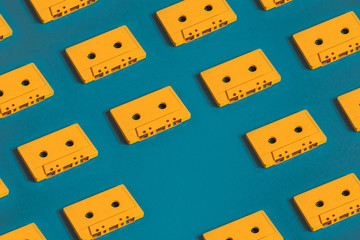 Yellow Retro Audio Cassette Tapes On Blue Background, Flat Lay. Creative Concept Of Retro Technology