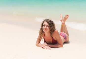 Lying down woman sunbathing on the beach