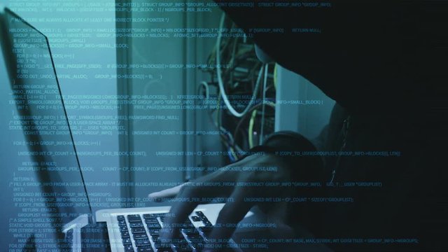 Hacker entering malicious code into data center.