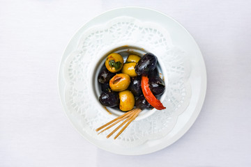 olives in white bowl on table