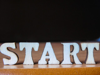 The word 'start' made of wooden letters. wood inscription