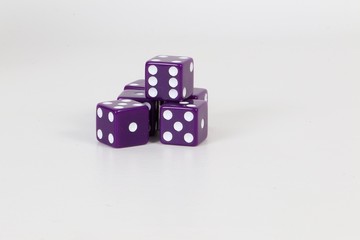 a heap of lilac dices are lying in the studio