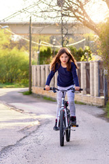 Cute Young Girl Riding A Bike. Child On Bicycle in the Neighborhood.
