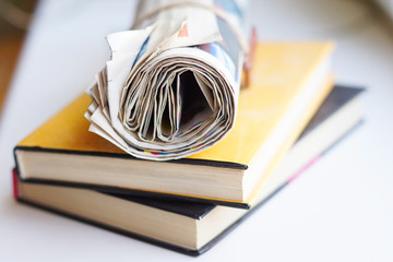 Pile of books and newspapers, side view, selective focus