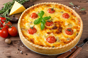 Freshly baked homemade pie quiche Lorraine on a wooden table