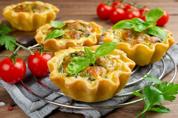 Baked homemade quiche pie in mini metal forms