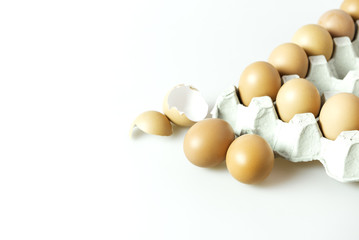 Raw chicken eggs in paper  container on isolated background.