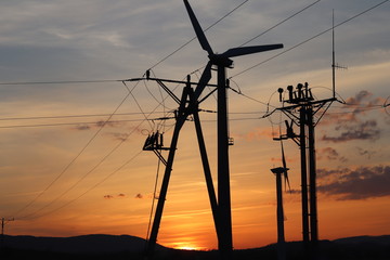 Wind power station in sunset. Romantic evening and modern technologies of ecologically clean...