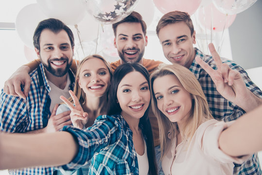 Creative, stylish, attractive, cheerful, beautiful, handsome business people having air balloons  shooting self portrait on front camera showing peace symbol two fingers celebrating event