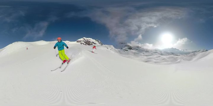 360 VR 4K couple skiing on ski slope on sunny winter vacation day
