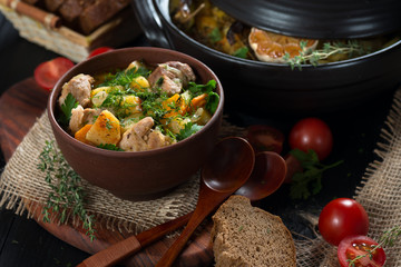 Roast in a clay pot rustic style view from above