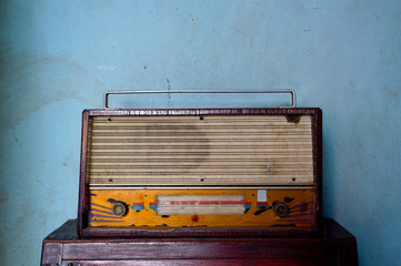 closeup old transistor radio on wood table with over light in the background
