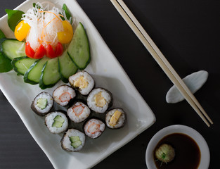 Sushi multiple stuffed Japanese food  on white dish with wasabi sauce