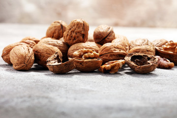 Walnut kernels and whole walnuts on rustic old table