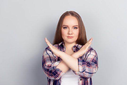 Young Woman With Wrists Crossed In Rejection Gesture