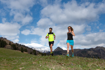 Couple of male and female athletes train in the mountains
