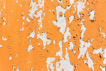 Texture of bright orange paints shabby metal wall