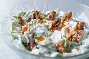 Walnut Salad with Purslane and Yogurt in Glass Bowl.