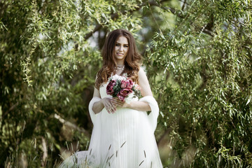 Brunette bride in fashion white wedding dress with makeup