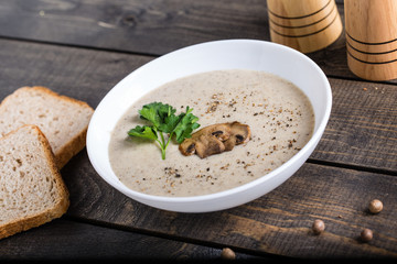 A bowl of mushroom soup cream on the table
