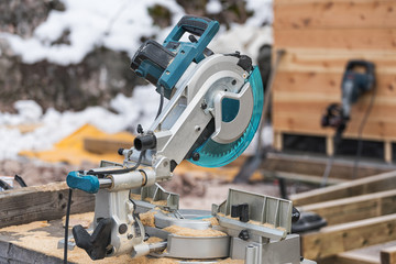 The lumberjack cutting the timber for lumber by circular saw.