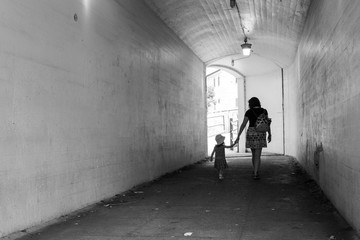 Greyscale image of mother and daughter in a tunnel