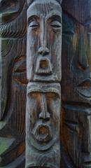 Fototapeta na wymiar Wooden Tree Sculpture: Close-up of Face Carved in Wood, Handmade.