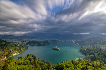 Scenic panoramic view of Lake Bled from above with moving clouds