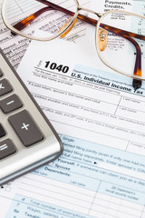 Tax form with glasses, and calculator