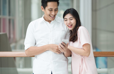 Fototapeta premium Happiness Two people using smart phones.