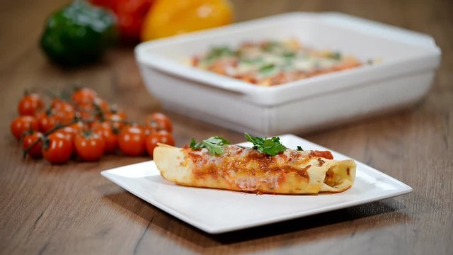 Homemade chicken enchiladas in a white plate